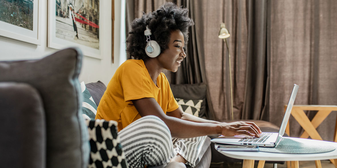 Women on a sofa using a laptop